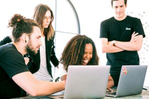 Dedicated teams collaborating - diverse group of professionals working together on startup development