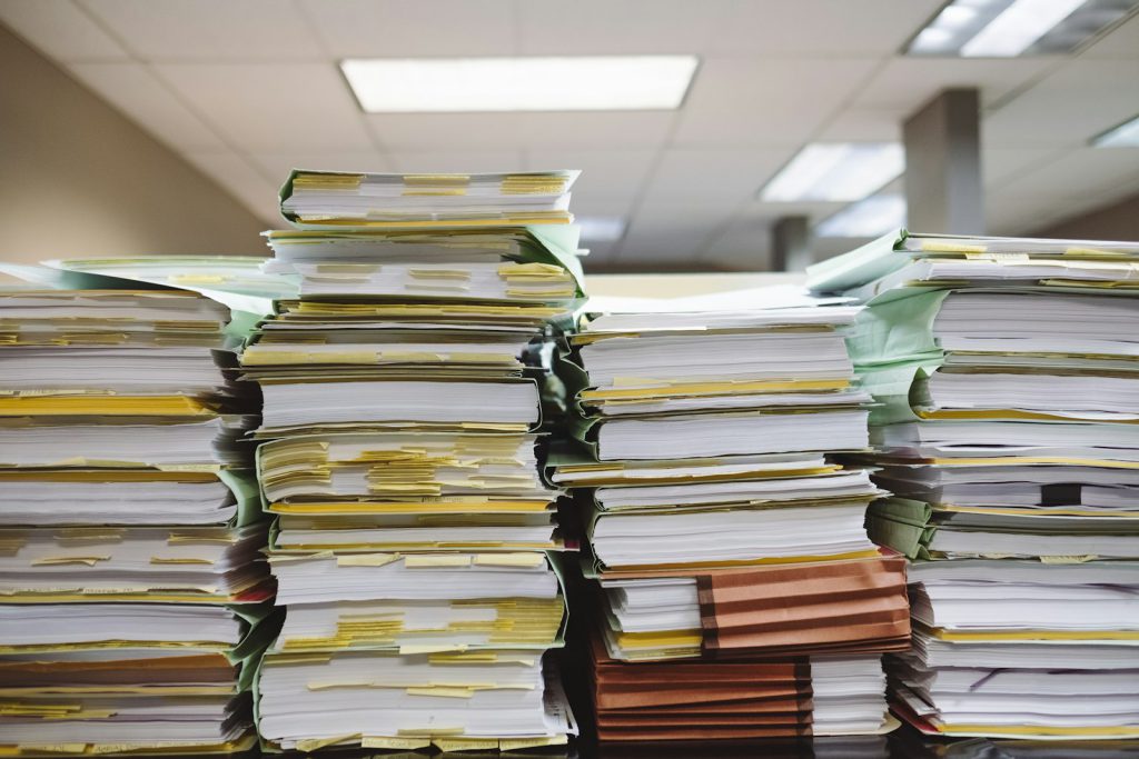ISO 42001 or ISO 27001 for your AI product? 2 Stacked documents and folders